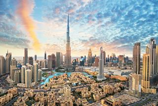 Panoramic view of Dubai showcasing skyscrapers against a vibrant sky | MSC Cruises