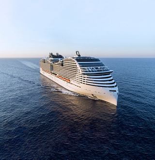 The MSC World Europa ship sails through calm waters, surrounded by sky and sea | MSC Cruises