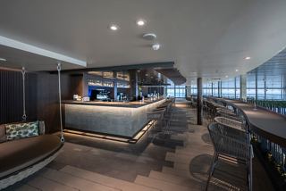 An elegant bar area featuring a stylish counter and modern seating in the Botanic Garden Bar | MSC Cruises