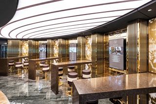 A stylish bar area in the MSC Seascape featuring elegant furniture and a warm atmosphere for relaxation | MSC Cruises