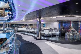 A stylish Champagne and Wine Bar featuring a sleek counter and elegant décor for socialising and relaxation | MSC Cruises