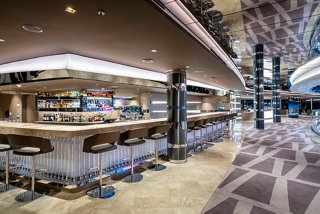 A stylish bar area with a modern counter and seating, inviting guests to enjoy refreshing beverages | MSC Cruises
