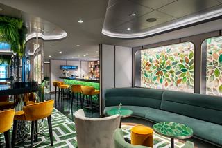 A stylish cocktail bar with a vibrant sitting area, featuring artwork and a welcoming atmosphere for guests | MSC Cruises