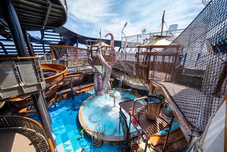 A vibrant view of the Pirates Cove Aquapark featuring a pool and adventure trail on MSC Seascape | MSC Cruises