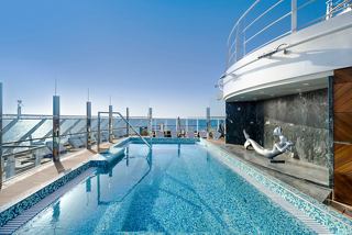 Luxurious sundeck with a sparkling pool and stunning ocean views onboard MSC Seascape | MSC Cruises