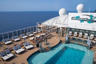 An inviting view of the MSC Yacht Club's pool area and sun deck overlooking the sea | MSC Cruises