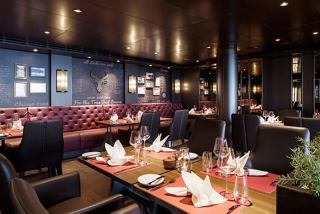 A warm and inviting setting in the Butcher's Cut restaurant aboard MSC Seascape | MSC Cruises