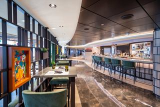 A vibrant dining area featuring a bar counter and stylish seating for an inviting culinary experience | MSC Cruises