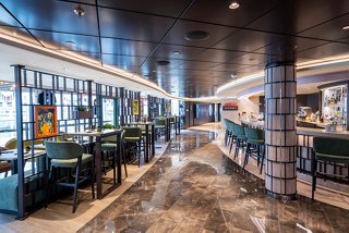 Guests walking near pool with towel service and loungers | MSC Cruises