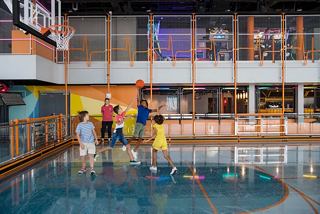 Families enjoy playful moments at the MSC Sportplex, engaging in basketball activities together | MSC Cruises