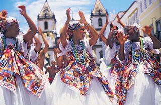 A vibrant celebration with dancers in traditional attire joyfully participating in a cultural event in Salvador de Bahia | MSC Cruises