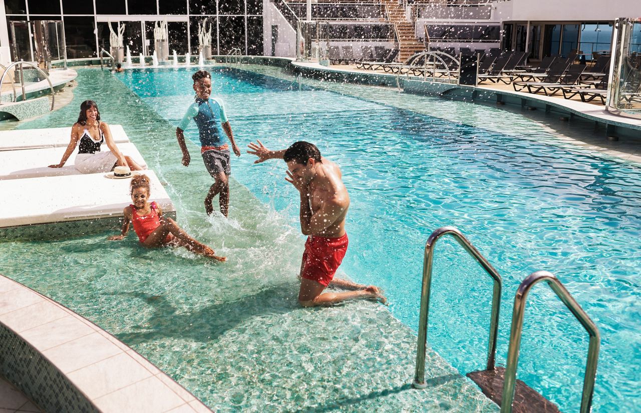 Une famille profite de moments ludiques au bord de la piscine La Plage, créant ensemble des souvenirs précieux | MSC Croisières