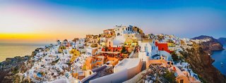 A breathtaking sunset view over the cliffs of Oia in Santorini, Greece, showcasing the beauty of the Mediterranean | MSC Cruises