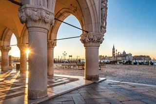 Sunlight filters through a beautiful archway, showcasing the stunning architecture of Venice | MSC Cruises