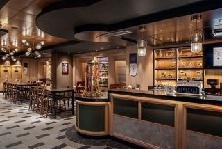 A welcoming bar area featuring modern design elements and comfortable seating for guests to enjoy their time together | MSC Cruises