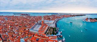 Aerial view of Venice showcasing its canals, historic architecture, and vibrant rooftops | MSC Cruises