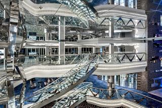 A stunning view of the Infinity Atrium featuring elegant stairs and the Champagne Bar, inviting relaxation and socialising | MSC Cruises