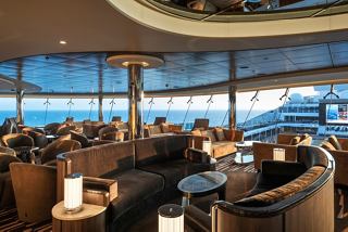 A spacious Sky Lounge with comfortable seating and panoramic views of the sea, inviting relaxation and connection | MSC Cruises
