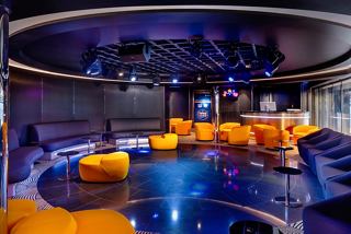 A vibrant lounge area with modern seating and a spacious dance floor invites relaxation and socialising | MSC Cruises