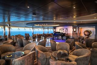 A spacious Sky Lounge with elegant seating and a stunning sea view, perfect for relaxation and socialising | MSC Cruises