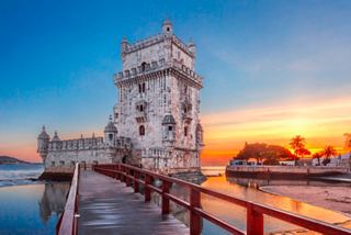 The iconic Belem Tower stands majestically by the Tagus River at sunset in Lisbon, Portugal | MSC Cruises