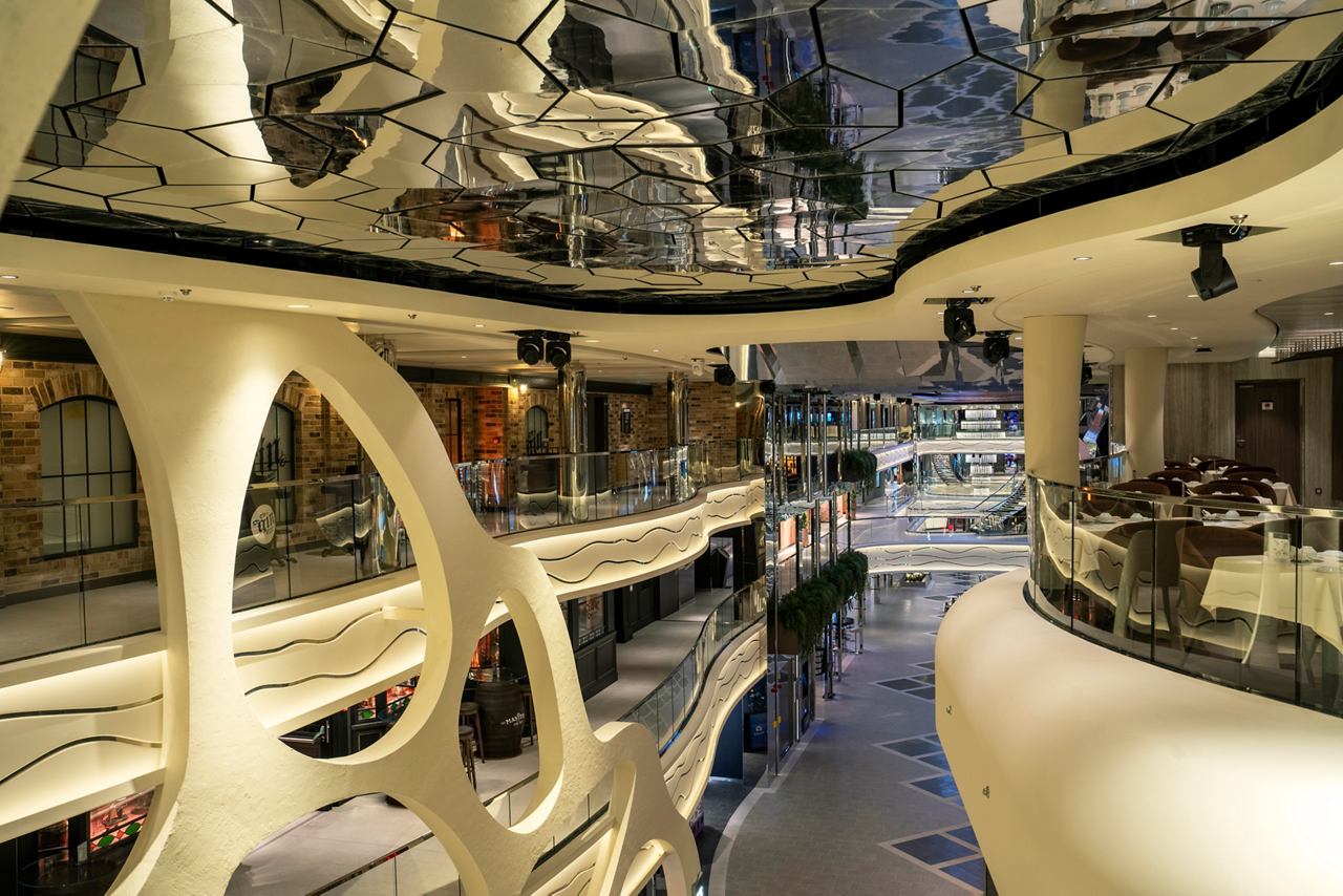 A stunning view of the vibrant entertainment area in MSC World Europa, showcasing elegant design and inviting spaces | MSC Cruises