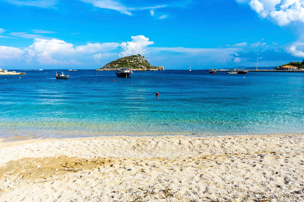 A serene beach with golden sand and clear turquoise waters, perfect for relaxation and exploration | MSC Cruises