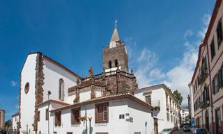 A historic church stands majestically against a clear blue sky in Funchal, Portugal | MSC Cruises