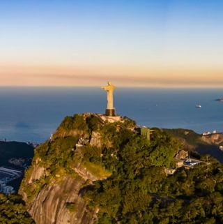 The Christ the Redeemer statue stands tall over Rio de Janeiro and the ocean | MSC Cruises
