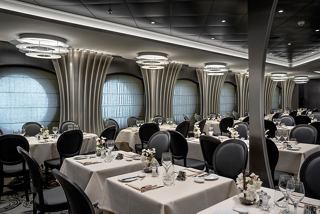 Elegant dining area on MSC Euribia with porthole views and stylish table settings | MSC Cruises