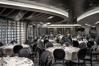 Elegant dining space in the MSC Euribia featuring tables, glass walls, and a warm atmosphere for a memorable experience | MSC Cruises