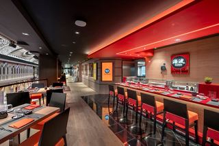 A vibrant interior of the Kaito Sushi Bar featuring a sleek counter and inviting seating | MSC Cruises