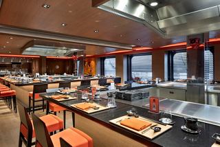 A vibrant dining area in Kaito Teppanyaki, featuring spacious seating and large windows for natural light | MSC Cruises