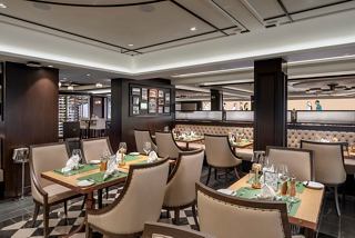 Elegant restaurant interior featuring tables set for dining, inviting guests to savour exquisite culinary experiences | MSC Cruises