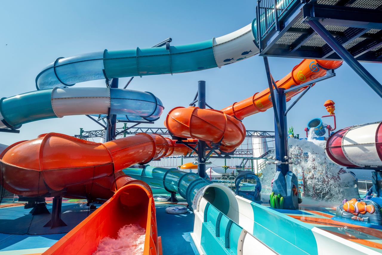 Aquapark with vibrant waterslides, inviting fun and adventure for all ages under the bright sky | MSC Cruises
