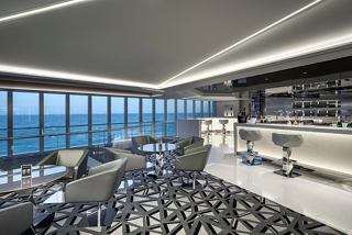 A stylish lounge area with comfortable seating and panoramic ocean views inviting relaxation and socialising | MSC Cruises