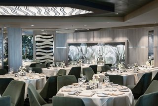 Elegant dining area in the Green Orchid restaurant featuring neatly set tables and inviting decor | MSC Cruises