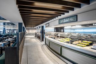 A spacious restaurant area with a buffet setup, inviting guests to enjoy diverse dining options | MSC Cruises