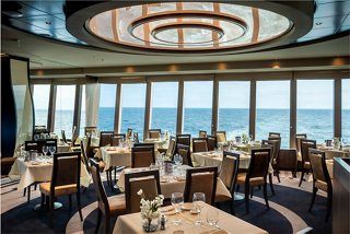 A beautifully arranged restaurant with panoramic sea views, inviting guests to enjoy delightful dining experiences | MSC Cruises