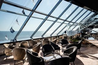 A bright and inviting lounge area with panoramic sea views and comfortable seating | MSC Cruises