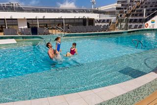 Families enjoying quality time together in the pool on MSC World Europa, creating unforgettable summer memories | MSC Croisières