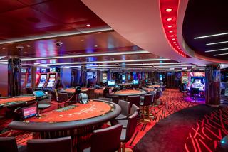 An inviting casino area on MSC Euribia, featuring gaming tables and vibrant lighting for entertainment | MSC Cruises