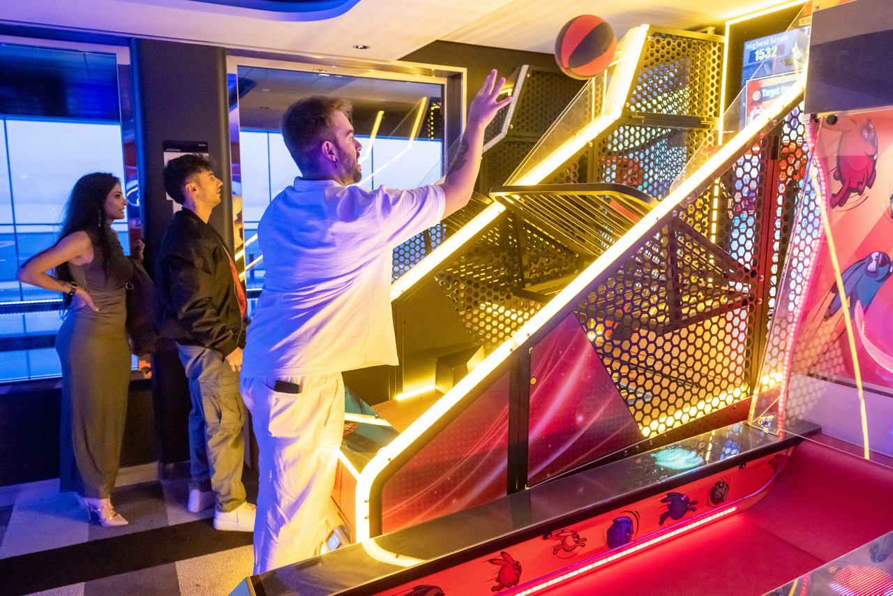 Guests enjoying the vibrant entertainment area with a stunning staircase on MSC Euribia | MSC Cruises
