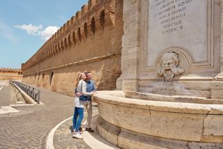A visitor enjoys the serene atmosphere by a historic fountain in Civitavecchia | MSC Cruises