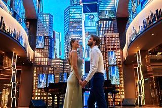 A couple shares a romantic moment in a vibrant setting aboard MSC Seashore | MSC Cruises