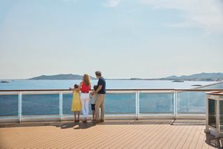 A family enjoys the stunning coastal view together on the deck of MSC Seashore | MSC Cruises