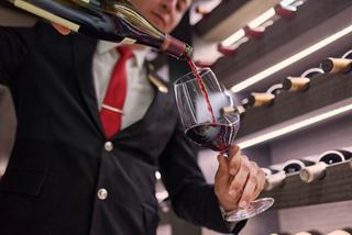 A sommelier expertly pours wine in The Wine Cellar on MSC Seashore, enhancing the onboard dining experience | MSC Cruises