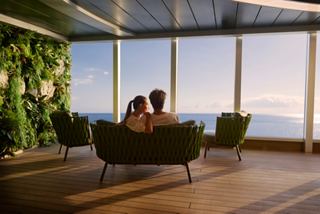 A couple enjoys a relaxing moment together, surrounded by greenery and panoramic sea views at the Jungle Pool Lounge | MSC Cruises