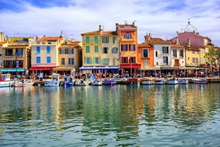 Charming colourful buildings reflect in the calm waters of the Cassis harbour in France | MSC Cruises