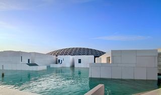Louvre Abu Dhabi's stunning architecture reflects on water under a clear sky | MSC Cruises